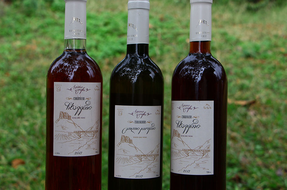 Three wine bottles with white labels